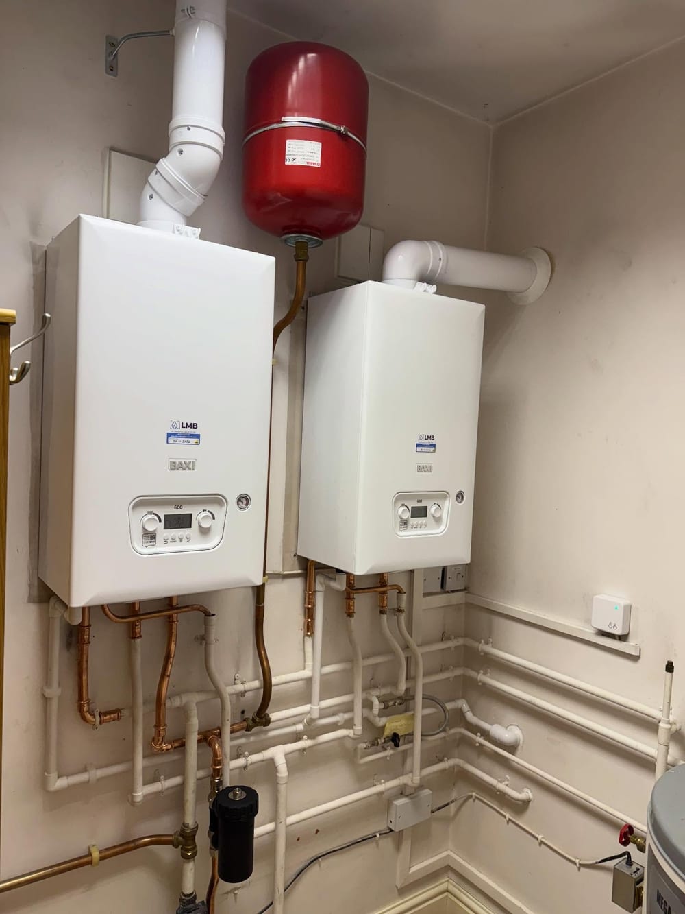 Two boilers, an expansion vessel and a hot water cylinder in a plant room